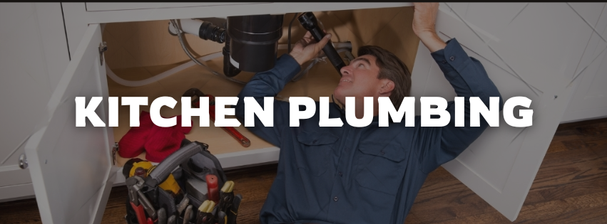 man doing kitchen plumbing under a sink